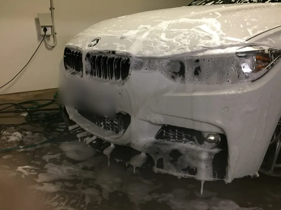 White BMW covered in foam during the exterior wash